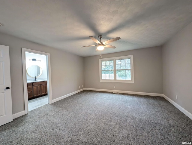 empty room featuring ceiling fan and light carpet