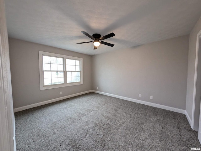 unfurnished room with carpet floors, ceiling fan, and baseboards