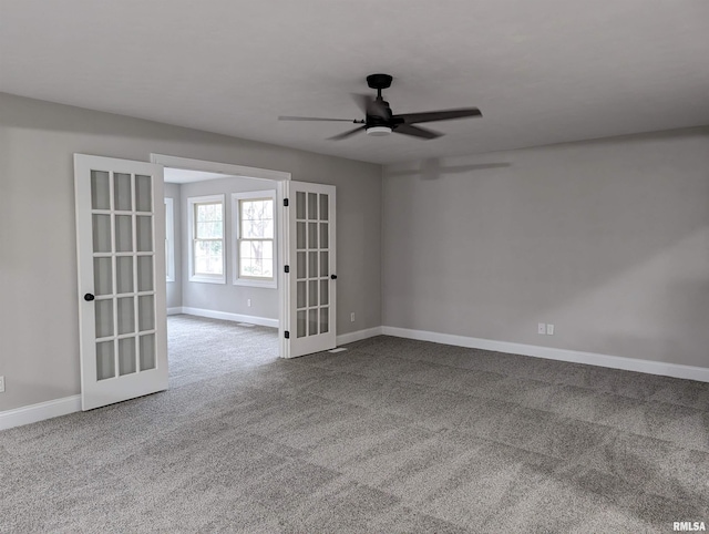 spare room featuring carpet flooring, ceiling fan, and french doors