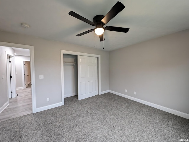 unfurnished bedroom featuring light colored carpet, a closet, and ceiling fan