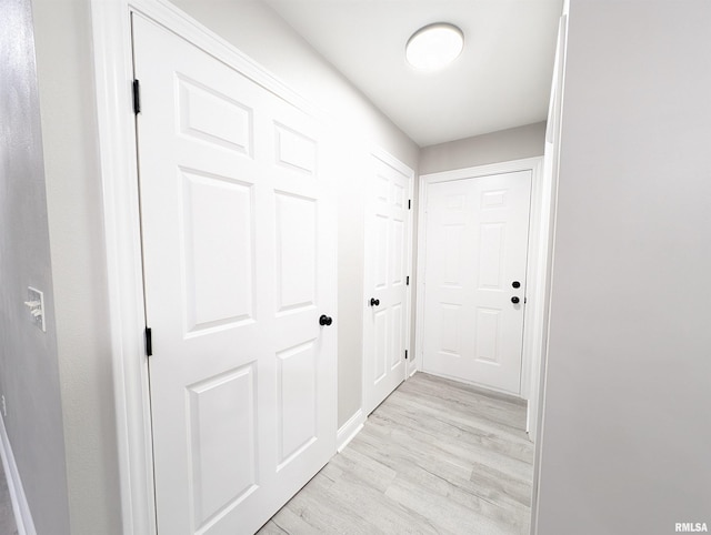 hallway with light hardwood / wood-style flooring