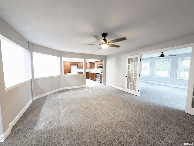 unfurnished room with ceiling fan, french doors, carpet, and baseboards