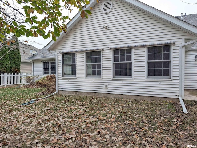 view of property exterior featuring fence