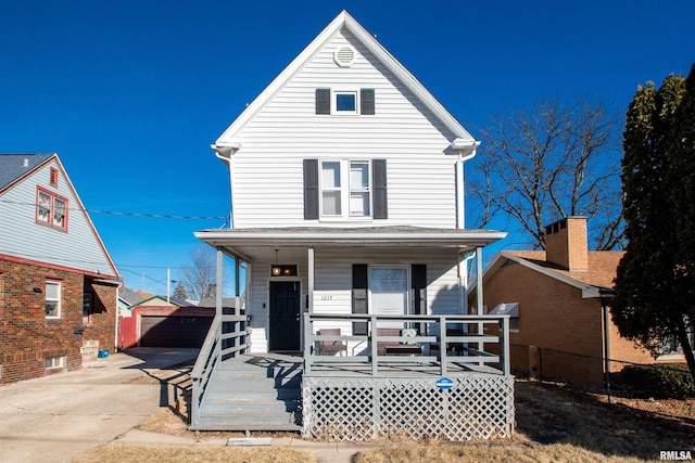 front of property featuring an outbuilding, a garage, and covered porch