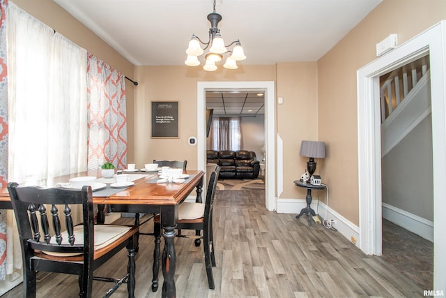 dining space with an inviting chandelier, hardwood / wood-style floors, and a wealth of natural light