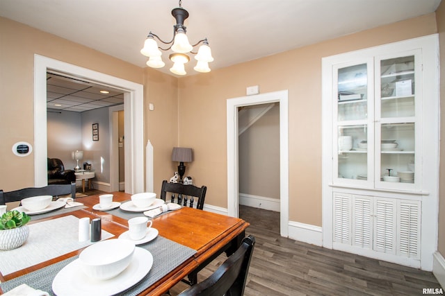 dining area with a chandelier and dark hardwood / wood-style flooring