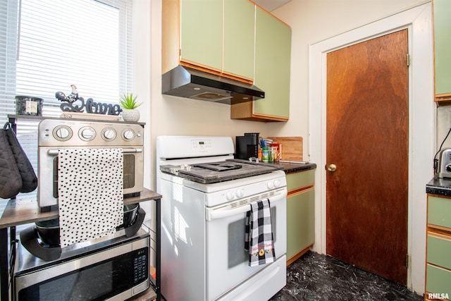 kitchen with white gas range and green cabinets