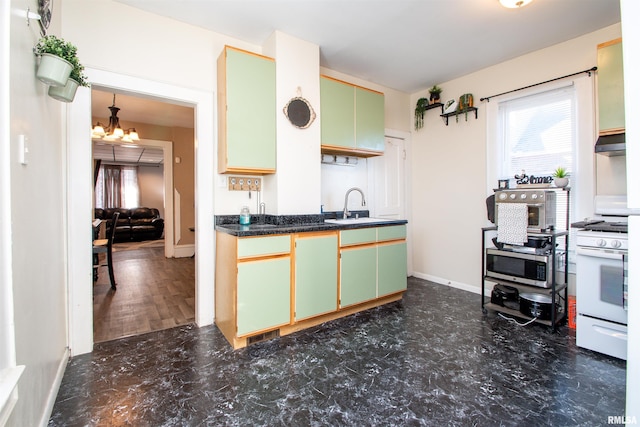 kitchen featuring white range with gas cooktop, sink, a chandelier, and green cabinets