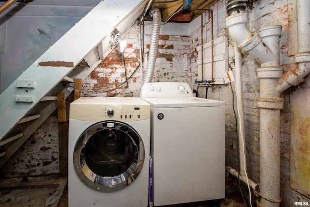 clothes washing area with washer and clothes dryer