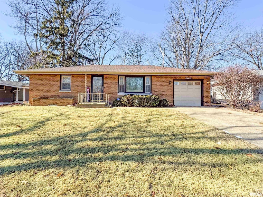 ranch-style house with a garage and a front lawn