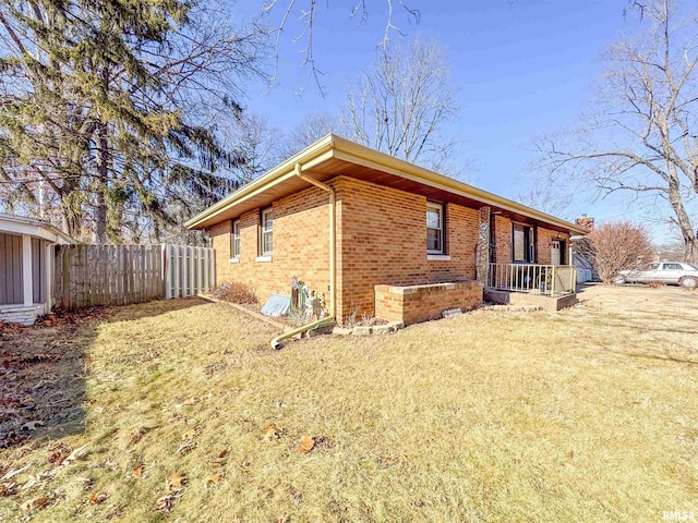 view of side of home featuring a yard