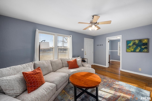 living room featuring dark hardwood / wood-style floors and ceiling fan