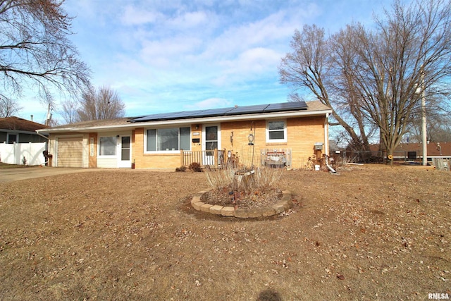 ranch-style house with solar panels