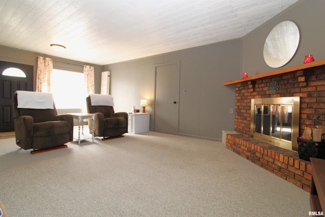 carpeted living room featuring a brick fireplace