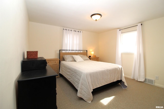 bedroom with dark colored carpet