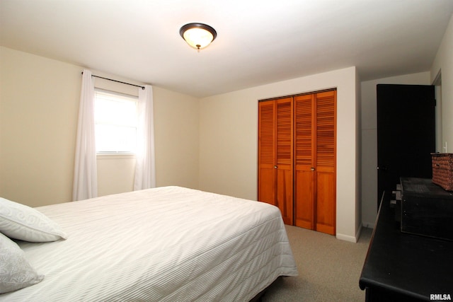 bedroom with a closet and light carpet