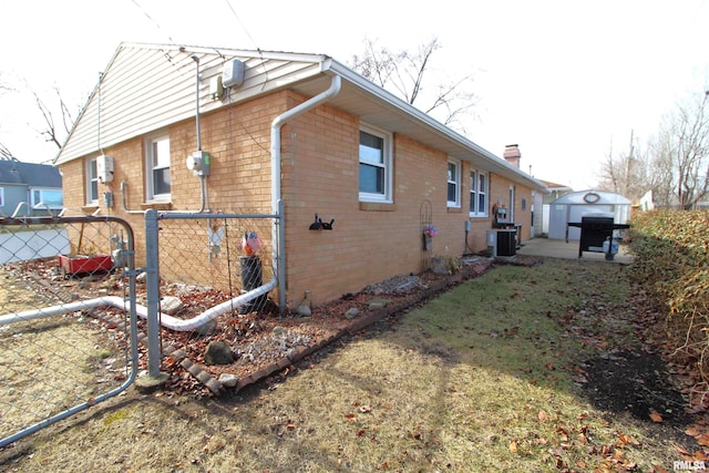 view of property exterior with an outdoor structure and cooling unit