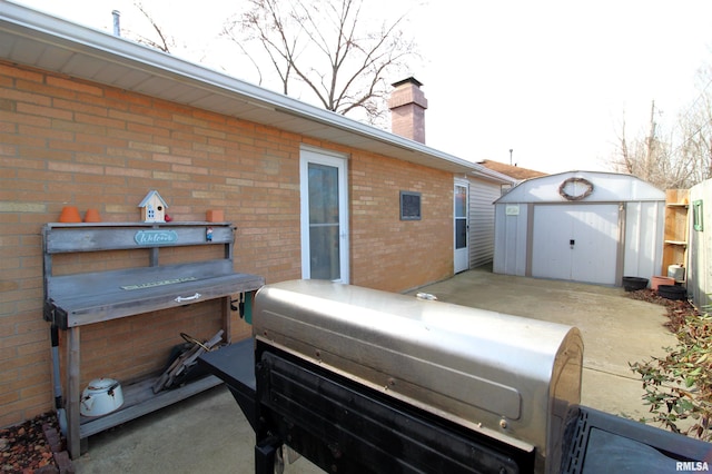 rear view of house with a patio area and a storage unit