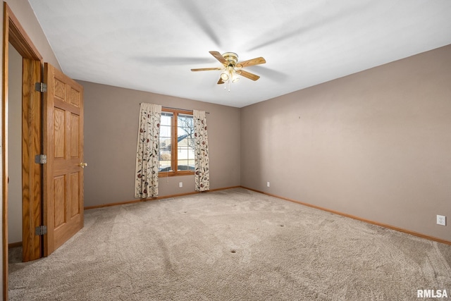 spare room featuring ceiling fan and carpet floors