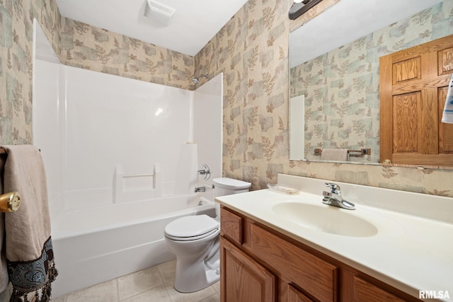 full bathroom with tile patterned flooring, vanity, tub / shower combination, and toilet