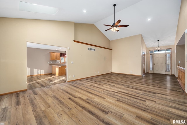 unfurnished living room featuring ceiling fan, high vaulted ceiling, and light hardwood / wood-style flooring