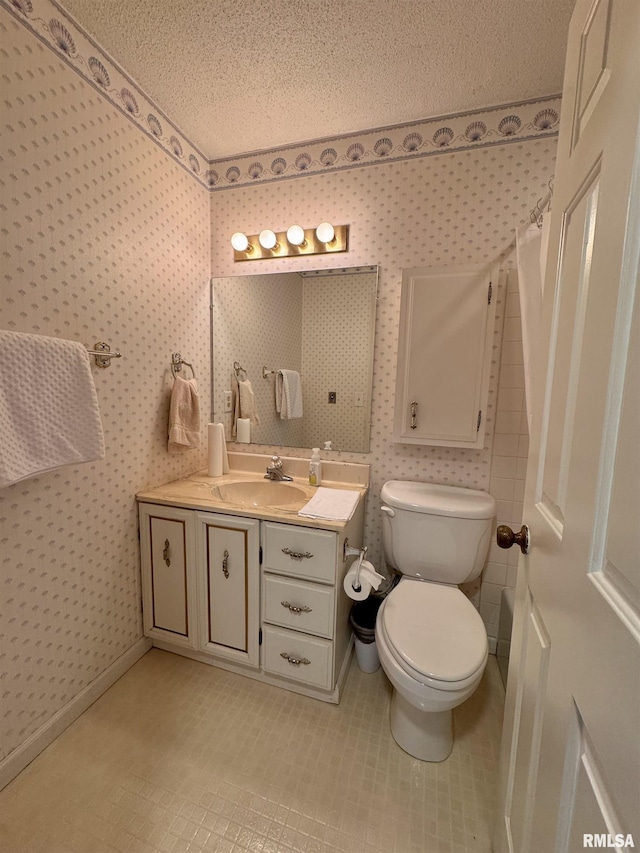 bathroom featuring vanity, curtained shower, toilet, and a textured ceiling