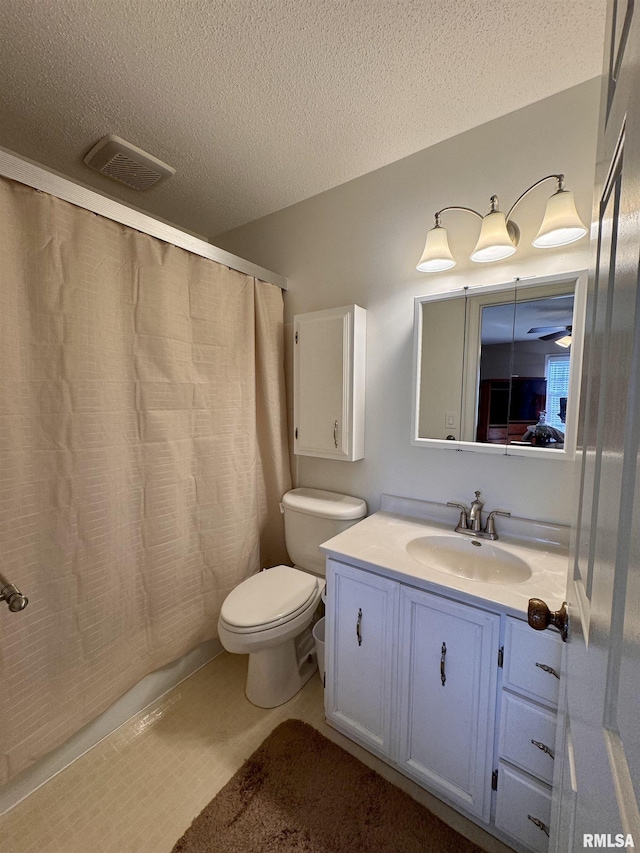 bathroom featuring vanity, curtained shower, toilet, and a textured ceiling