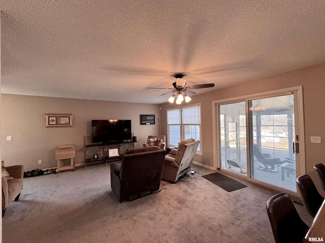 living room featuring carpet floors, a wealth of natural light, and ceiling fan