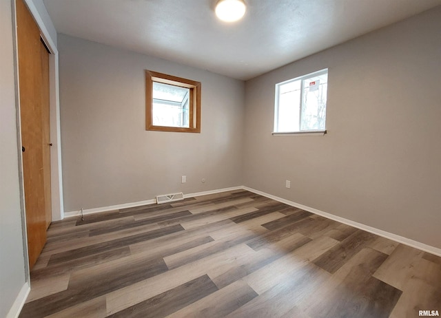 unfurnished bedroom featuring dark wood-type flooring and a closet