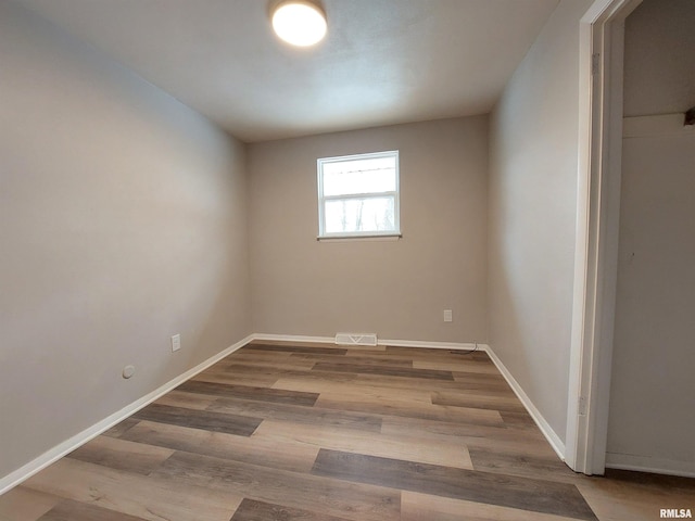 unfurnished room with hardwood / wood-style floors