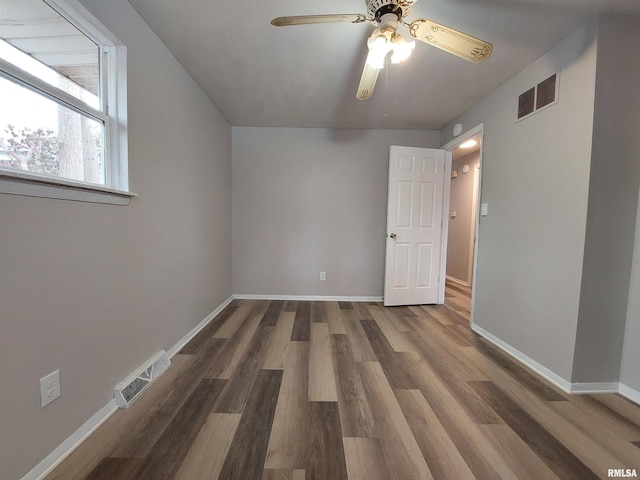 bonus room with ceiling fan and dark hardwood / wood-style flooring