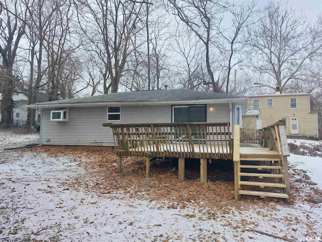 snow covered rear of property featuring a deck