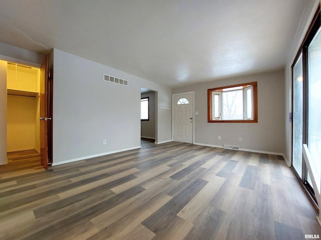 unfurnished living room featuring dark wood-type flooring