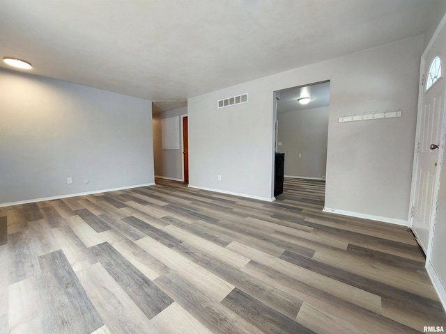 empty room with hardwood / wood-style flooring