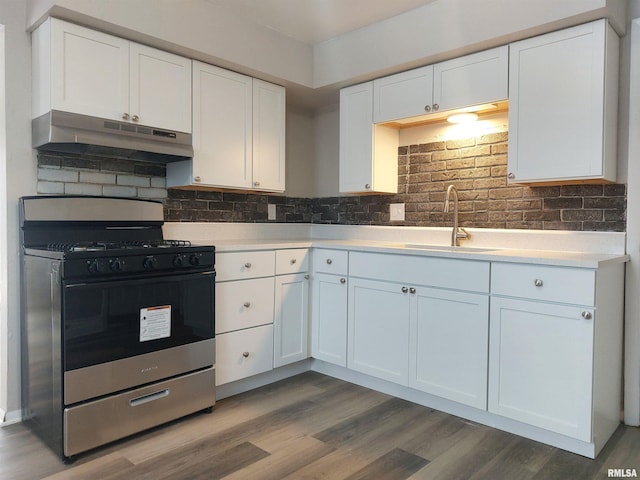 kitchen featuring sink, gas range, white cabinets, and backsplash