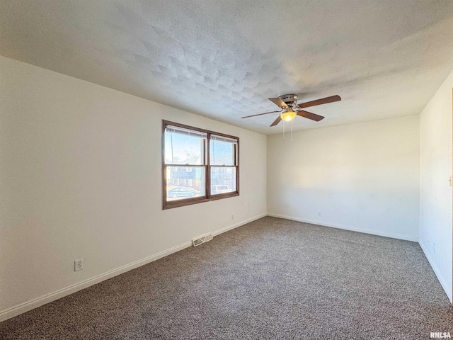 carpeted spare room featuring a textured ceiling, a ceiling fan, visible vents, and baseboards