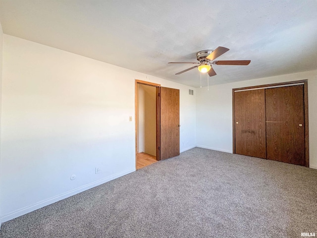 unfurnished bedroom with light carpet, baseboards, visible vents, ceiling fan, and a closet