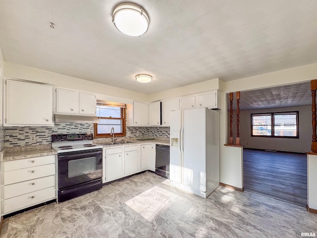 kitchen with plenty of natural light, range with electric cooktop, dishwasher, light countertops, and white fridge with ice dispenser