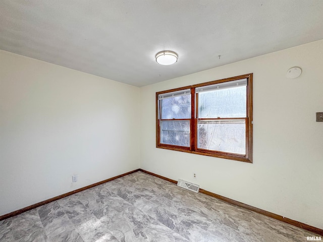 unfurnished room featuring visible vents and baseboards