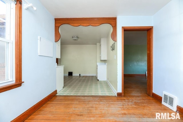 hallway with light hardwood / wood-style floors