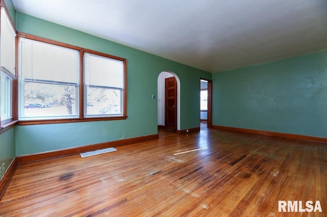 empty room with hardwood / wood-style flooring