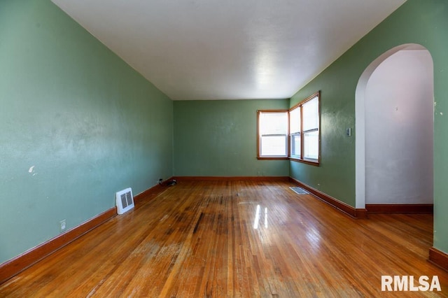 unfurnished room featuring hardwood / wood-style flooring