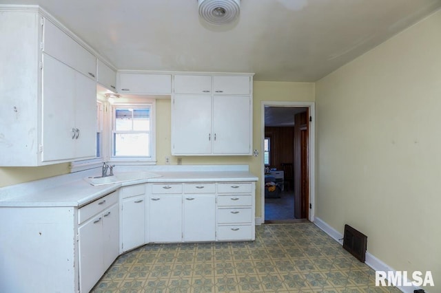 kitchen featuring sink and white cabinets