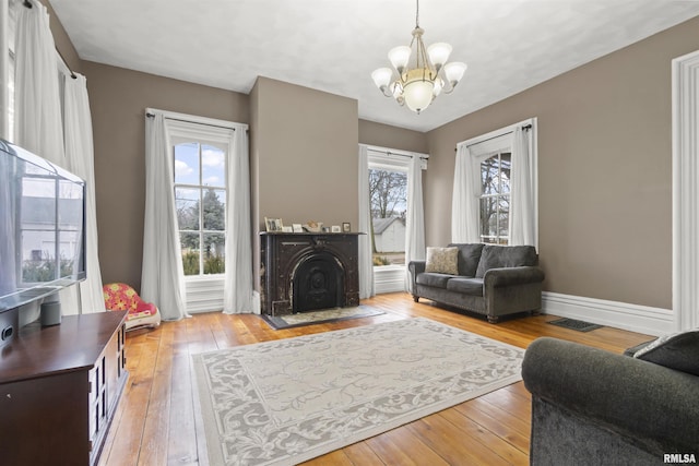 living room with light hardwood / wood-style flooring and a chandelier