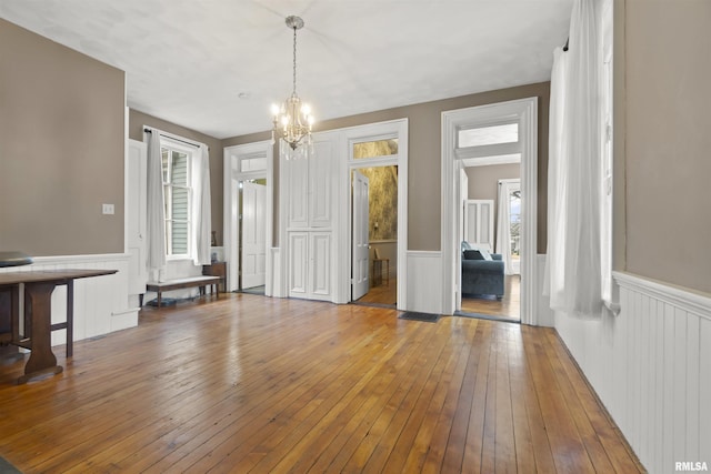 interior space featuring wood-type flooring and a chandelier