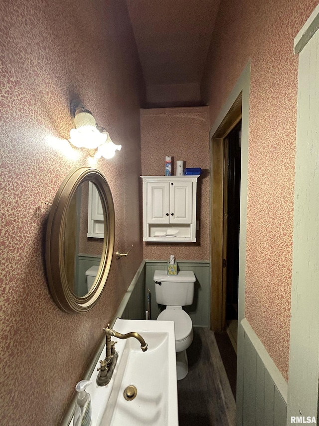 bathroom with radiator heating unit and toilet