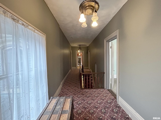 corridor featuring a chandelier