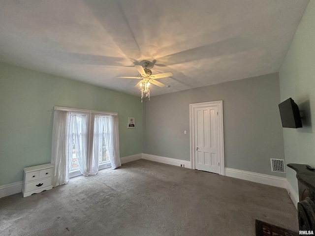 interior space with carpet flooring and ceiling fan