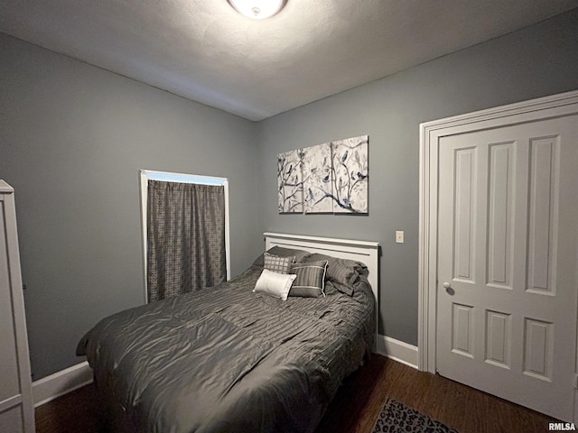 bedroom featuring dark hardwood / wood-style flooring