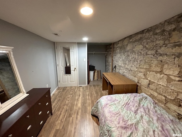 bedroom with hardwood / wood-style flooring and a closet